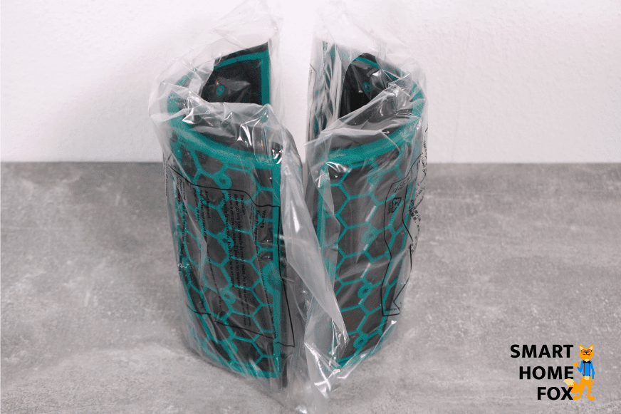 The round green activated carbon filter units from the Dyson Pure Hot + Cool HP04 air purifier face each other on a table